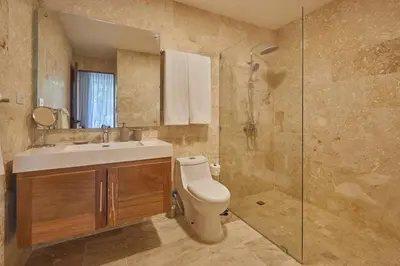 a bathroom with a toilet and a sink and a shower at Modern Escape with Pool & Beach in Puerto Plata