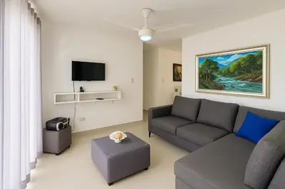 a living room with a couch and a tv at Relax cibao airport stay in Santiago de los Caballeros
