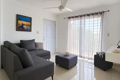 a living room with a couch and a chair at Relax cibao airport stay in Santiago de los Caballeros