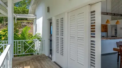 a room with a white door and a balcony at Casa Las Piedras in Las Terrenas