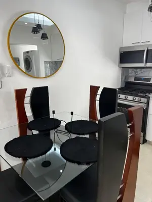 a dining room table with four chairs and a mirror at Luxurious and cozy apartment in San Luis
