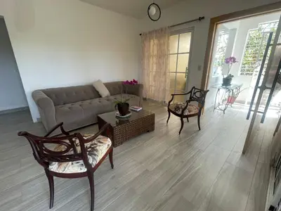 a living room with a couch and a table and chairs at Apartmento, siéntete en casa in Monte Adentro