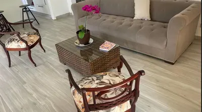 a living room with a couch and a table and chairs at Apartmento, siéntete en casa in Monte Adentro