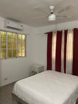 a bedroom with a bed and two windows at Apartmento, siéntete en casa in Monte Adentro