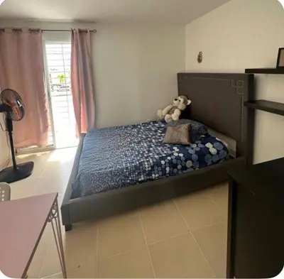 a bedroom with a bed with a teddy bear on it at Casa colinas del viento in Jacagua