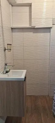 a bathroom with a sink and a large door at Apartamento Las Carreras in Santo Domingo