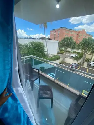 a view of a balcony with a table and chairs at Beautiful apartment near STGO airport in Santiago de los Caballeros