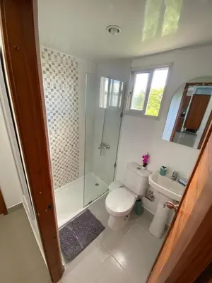 a bathroom with a toilet and a shower and a sink at Beautiful apartment near STGO airport in Santiago de los Caballeros