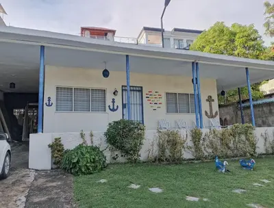 a white house with two birds in front of it at Villa Del Risco - House on the Beach in Boca Chica