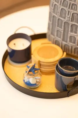 a table with a plate with a candle and cups at Luxurious Apartment with pool near airport in Santiago de los Caballeros