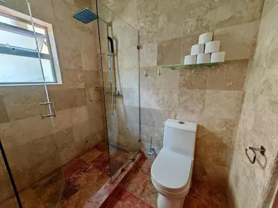 a bathroom with a toilet and a glass shower at Apartman Tamarindo in La Laguna