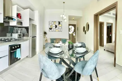 a kitchen and dining room with a glass table and chairs at Comfy 1BR Apt, Full AC, Pool. in Santo Domingo