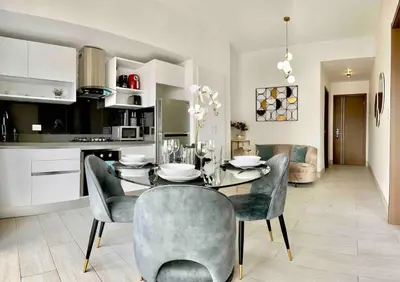 a kitchen and dining room with a table and chairs at Comfy 1BR Apt, Full AC, Pool. in Santo Domingo