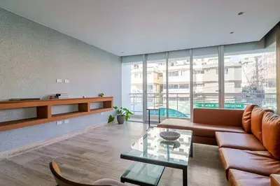 a living room with a couch and a glass table at Comfy 1BR Centric Apt King Bed in Santo Domingo