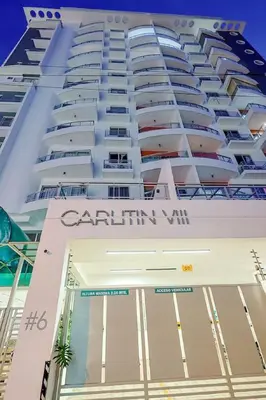 a large white building with the words caribbean vii at Comfy 1BR Centric Apt King Bed in Santo Domingo