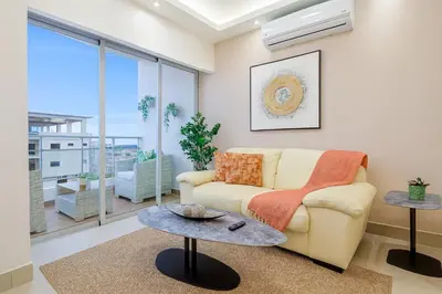 a living room with a couch and a table at Comfy 1BR Centric Apt King Bed in Santo Domingo