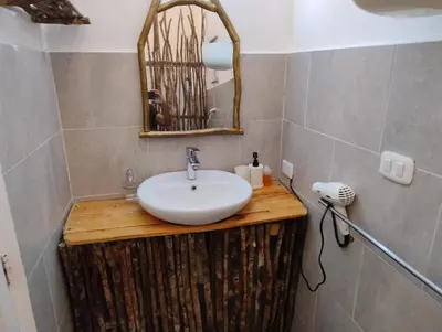 a bathroom with a sink and a mirror at Brisa de Alma Guesthouse in Bayahibe