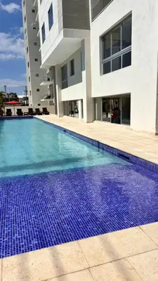 a large swimming pool in front of a building at Tropical Seaside Bliss DGM Resort at BocaChica in Boca Chica