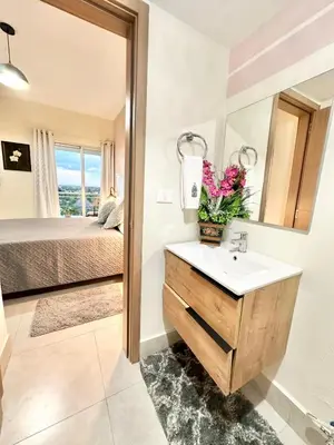 a bathroom with a sink and a bed at Tropical Seaside Bliss DGM Resort at BocaChica in Boca Chica