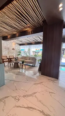 a lobby with a couch and tables in a building at Tropical Seaside Bliss DGM Resort at BocaChica in Boca Chica