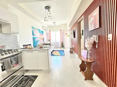 a kitchen with a stove and a table in it at Tropical Seaside Bliss DGM Resort at BocaChica in Boca Chica