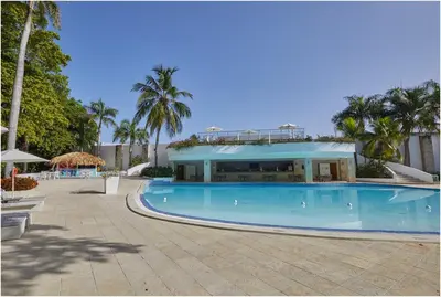 a large swimming pool in front of a building at Escape Oasis in Playa Dorada Pool & Beach in Puerto Plata
