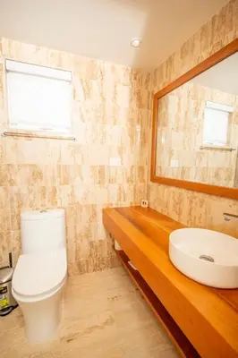 a bathroom with a toilet and a sink at Modern 2BR Caribbean Apt -Pool & Beach Access in Puerto Plata