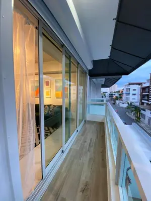 an office with glass windows and a view of a building at Apartamento tranquilo, céntrico y confortable in Santo Domingo
