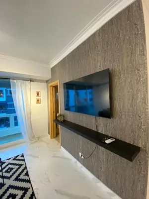a living room with a television on a wall at Apartamento tranquilo, céntrico y confortable in Santo Domingo