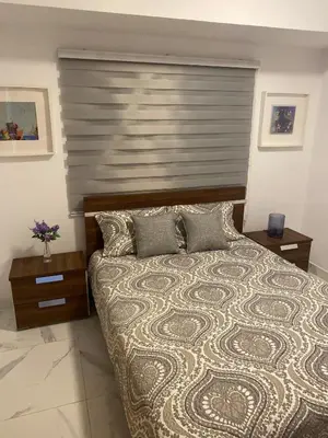 a bedroom with a large bed with a large headboard at Apartamento tranquilo, céntrico y confortable in Santo Domingo