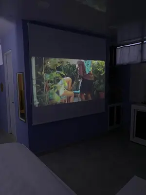a room with a tv with two people on it at Beach Days & City Nights! Centrally Near Everything in Santo Domingo