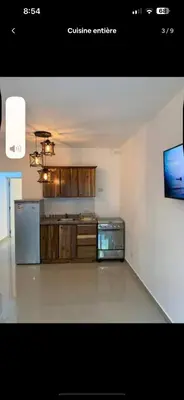 a kitchen with wooden cabinets and a stove at Jolie condo in Boca Chica