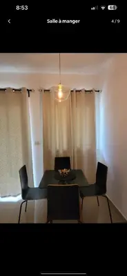 a dining room with a table and chairs and a light at Jolie condo in Boca Chica