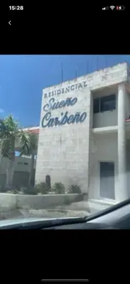 a building with a sign on the side of it at Jolie condo in Boca Chica