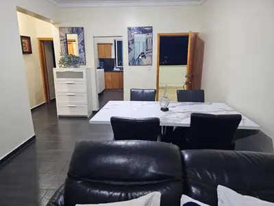 a dining room with a table and leather chairs at Dreamvillage in Boca Chica