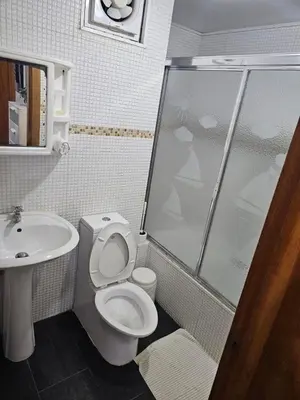a bathroom with a shower and a toilet and a sink at Dreamvillage in Boca Chica