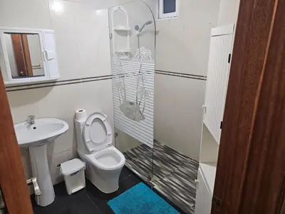 a bathroom with a toilet and a sink at Dreamvillage in Boca Chica