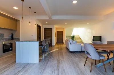 a kitchen and living room with a table and chairs at La Stuga del Mar - Walk to Portillo Beach, Terrenas in Las Terrenas