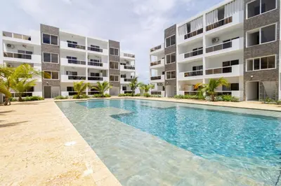 a swimming pool in front of a building at Cozy 1BR 1BA Bayahibe Getaway with Pool - Maravilla in San Rafael del Yuma
