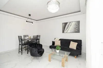 a living room with a black couch and a table at Cozy 1BR 1BA Bayahibe Getaway with Pool - Maravilla in San Rafael del Yuma
