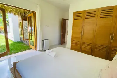 a bedroom with a bed and a large window at Bonita Beach Villa in Las Terrenas
