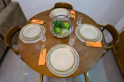 a wooden table with plates and bowls of food on it at Amazing 2BR apartment near the airport in Los Frailes