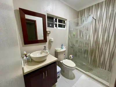 a bathroom with a sink and a toilet and a shower at Villa in Metro Country Club, Juan Dolio in Juan Dolio