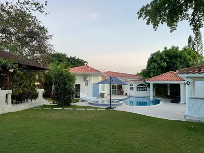 a house with a swimming pool in a yard at Villa in Metro Country Club, Juan Dolio in Juan Dolio