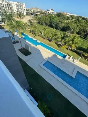 an overhead view of a swimming pool with palm trees at Apartamento de Lujo Punta Cana Hard Rock in Punta Cana