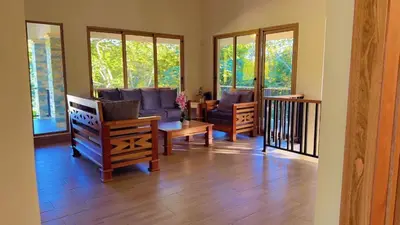a living room with a couch and chairs and windows at Villa Monaco RD in Concepción de La Vega