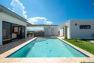 a swimming pool in the backyard of a house at Brand New Modern Caribbean Retreat 3BR in Sosúa