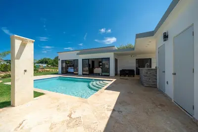a swimming pool in the backyard of a house at Brand New Modern Caribbean Retreat 3BR in Sosúa