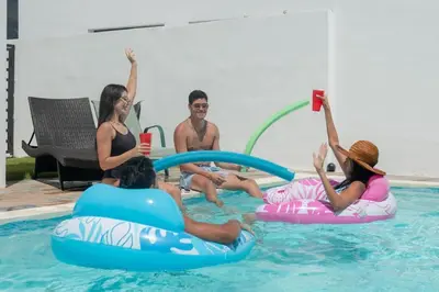 a group of people sitting on inflatables in a swimming pool at Luxury Villa with Private Pool in Punta Cana in Punta Cana