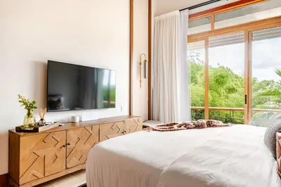 a bedroom with a large bed and a large window at Casa Cielo 3 BR Penthouse with Views in La Romana